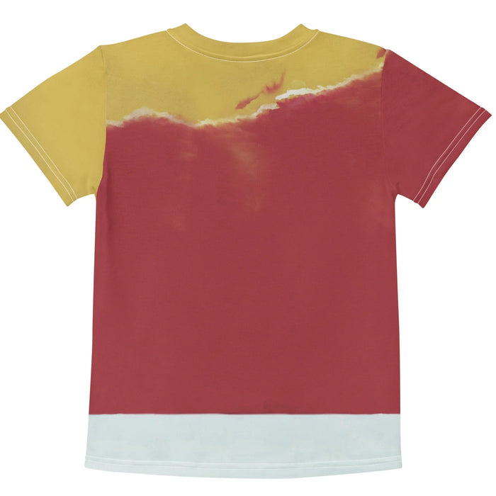 Kim Jong Trill Kid's Tee - The "Midnight Onyx" (#1A1A1A) triple-stripe tracksuit crouching pose contrasted against the "Propaganda Gold" (#CDA543) to "Revolutionary Crimson" (#962F2F) sky gradient.