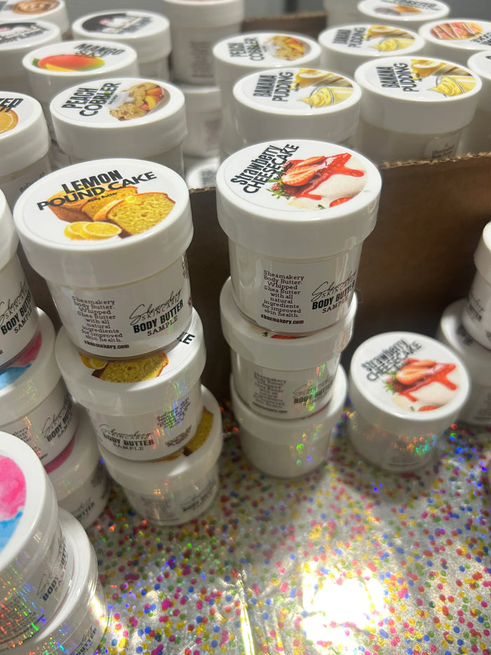 Assorted dessert-scented body butter jars with labels like lemon pound cake and strawberry cheesecake.