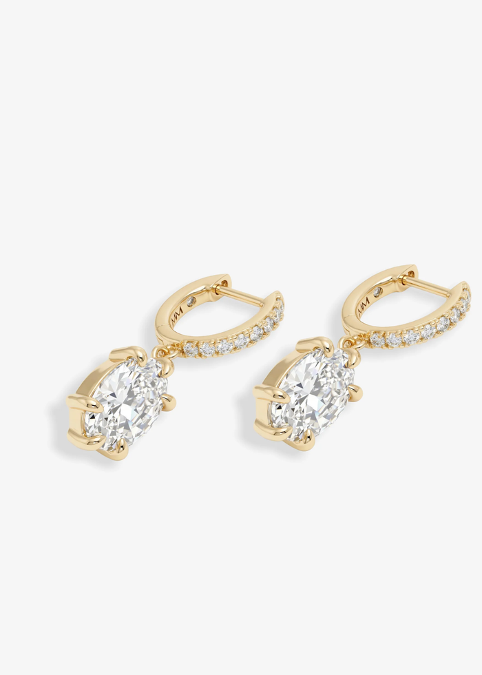 A pair of gold and simulated diamond huggie earrings