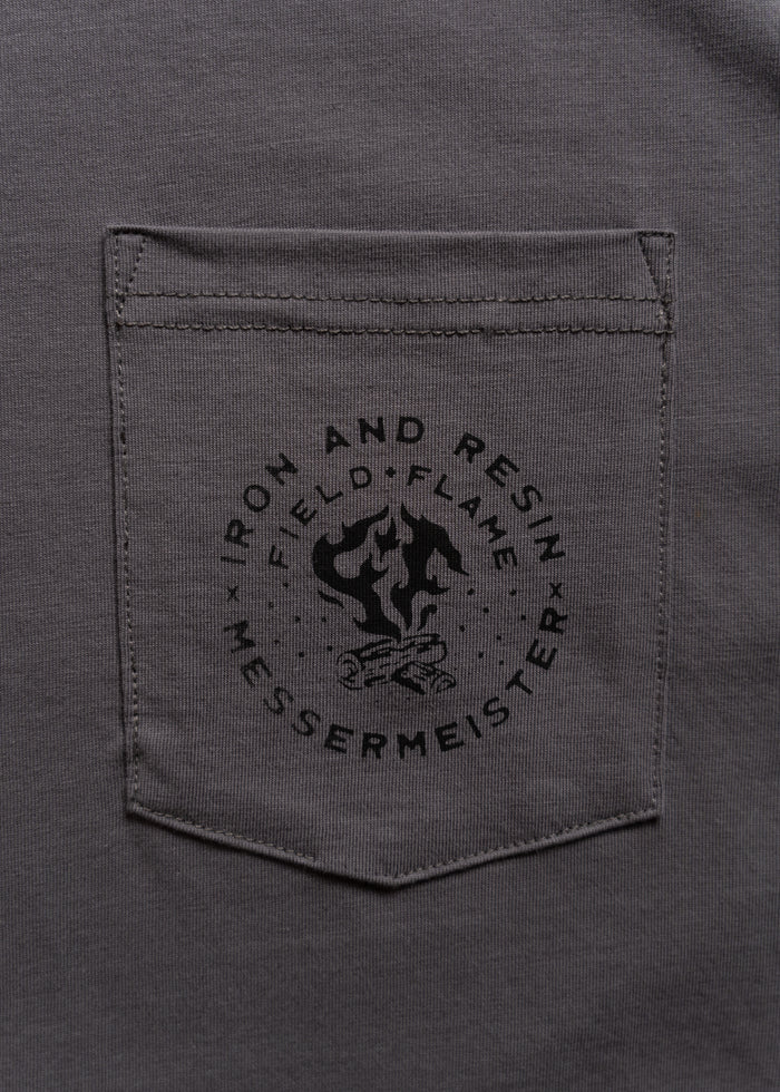 Gray shirt pocket with "Iron and Resin" logo featuring a campfire and the word "Messermeister" printed below.
