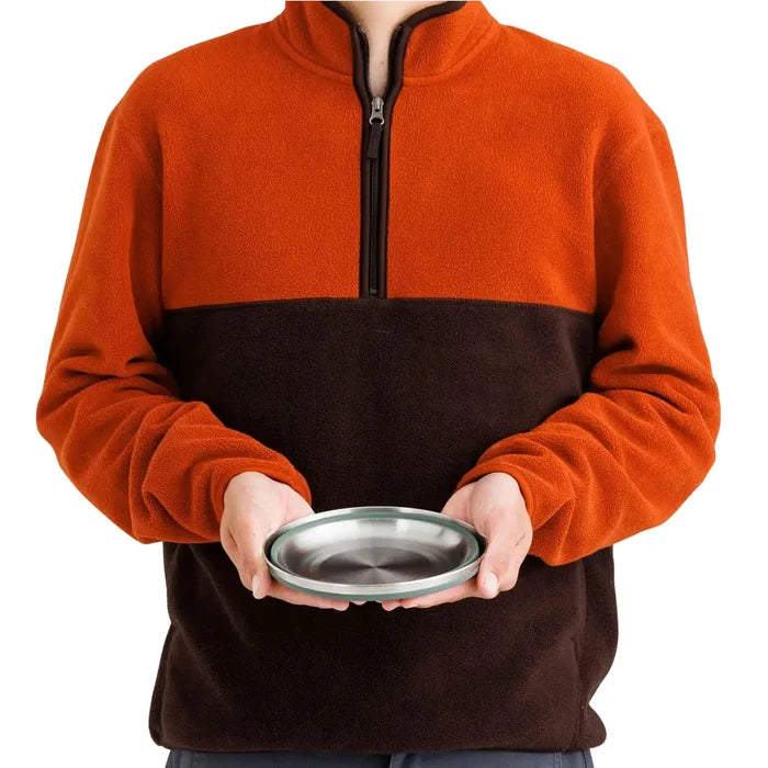 Person holding a fully collapsed Sea To Summit Detour Stainless Steel Collapsible Bowl in green colour to show the size equivalence