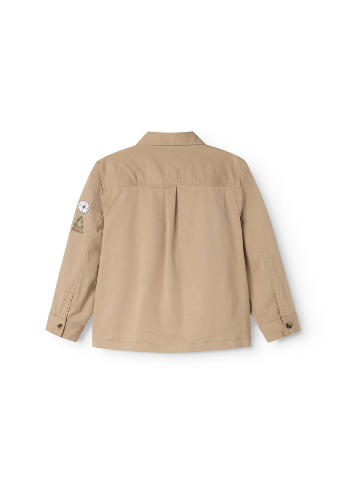 Beige jacket for children shown from the back with full back and sleeve decoration.