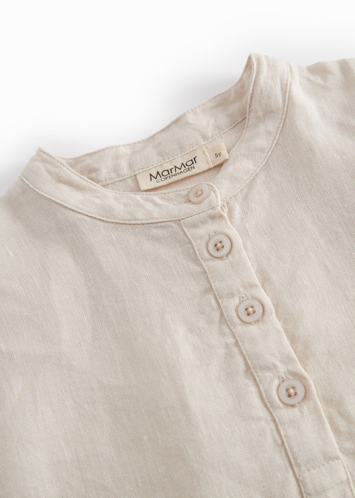 Beige long-sleeved shirt for children with a Mandarin collar and front button-up.