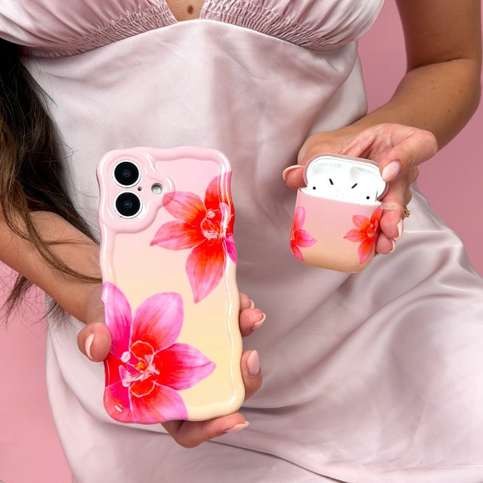 Girl holding matching pink orchid sunset phone case and airpods case