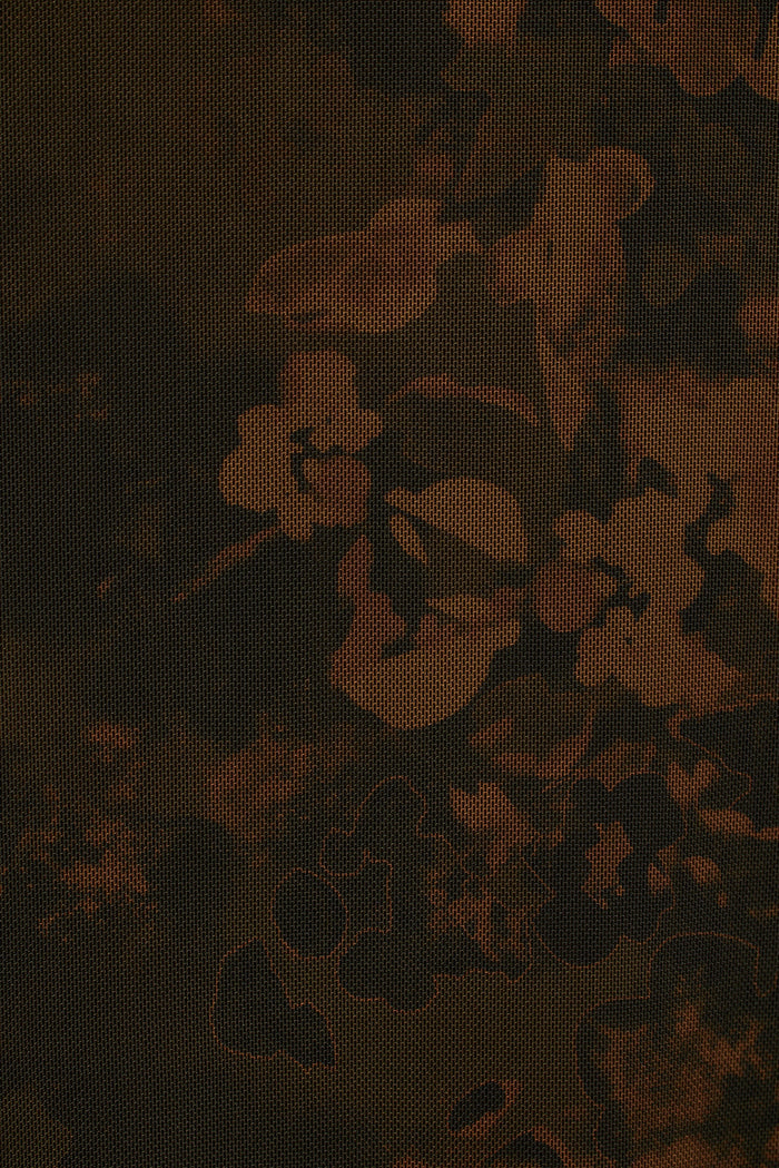 Close-up of the Amora dark floral mesh fabric, rust blooms on black netting.