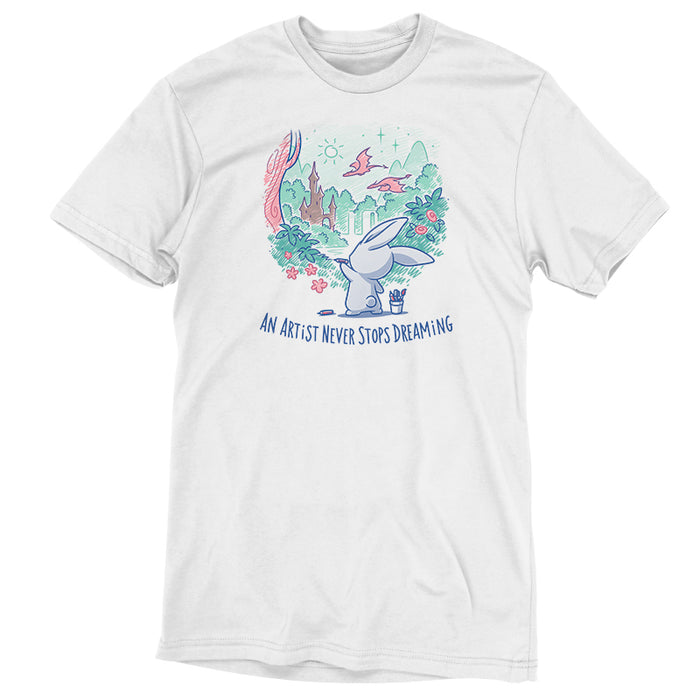 Premium Cotton T-shirt_TeeTurtle white An Artist Never Stops Dreaming apparel  featuring a bunny drawing a whimsical landscape with a castle, trees, and flying dragons. Caption reads, "an artist never stops dreaming".
