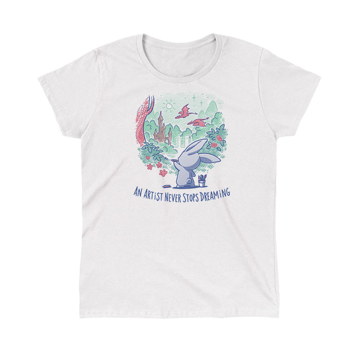Classic Cotton T-shirt_TeeTurtle white An Artist Never Stops Dreaming apparel  featuring a bunny drawing a whimsical landscape with a castle, trees, and flying dragons. Caption reads, "an artist never stops dreaming".