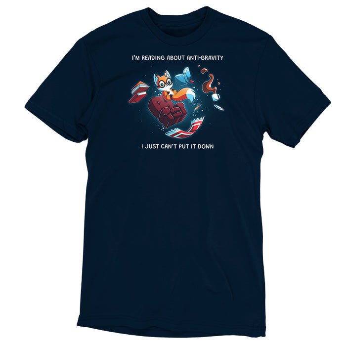 Premium Cotton T-shirt_TeeTurtle navy blue Anti-Gravity Enthusiast apparel featuring a fox wearing glasses reading a book with floating in mid-air with its living room furniture, such as a chair, rug, and lamp, with the caption, “I’m Reading About Anti-Gravity, I Just Can’t Put It Down“.