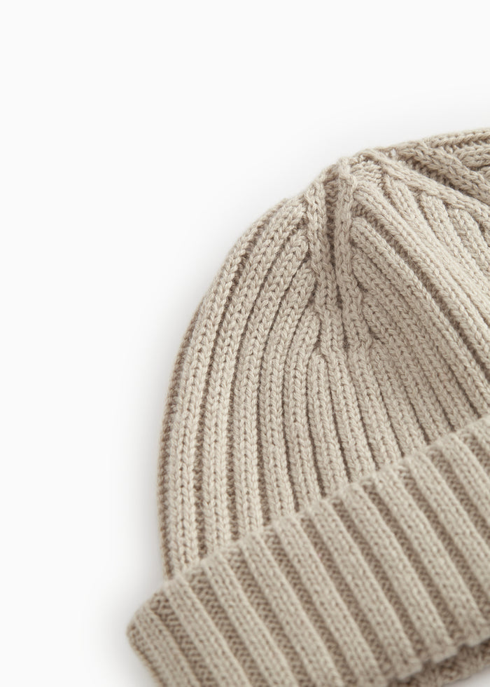Details of a barely beige stripe hue with vertical ribs and a folded edge.