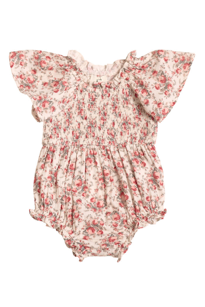 The Ivy City Co Baby Jovie Romper in Ivory Heritage Rose features a pink and green floral print, short ruffled sleeves, smocked bodice, and elastic legs—perfect for adorable Mom and Me matching outfits.