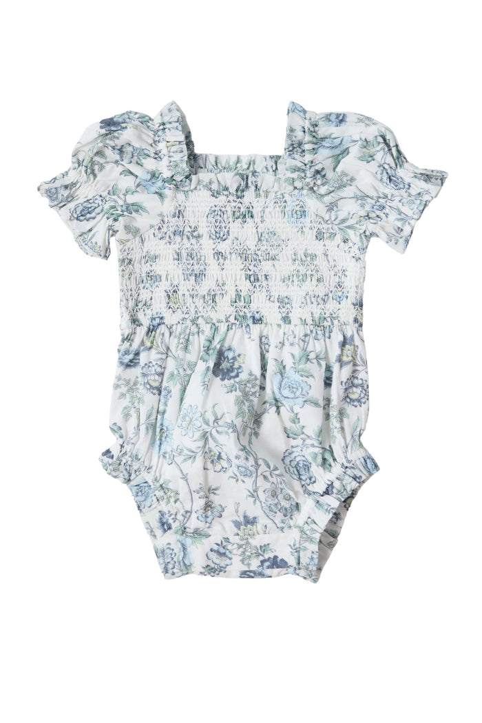 The Baby Valencia Romper in Ivory Climbing Vine Bloom by Ivy City Co features ruffled short sleeves, a shirred bodice, and an ivory floral print on a white background, all crafted from soft cotton.