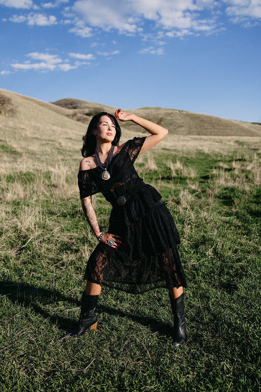 Black lace western midi dress styled for gothic cowgirl outfits, country concert fashion, western festival outfits, and edgy cowgirl style from Sand + Charcoal Boutique.