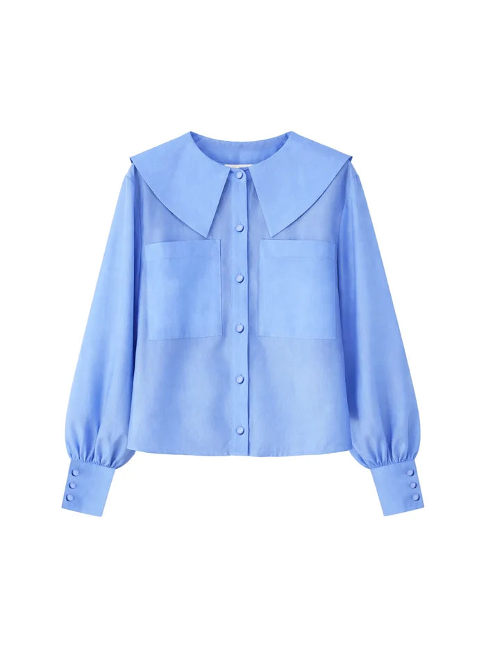 Soft blue sheer blouse with statement collar, pocket detail and deep cuffs