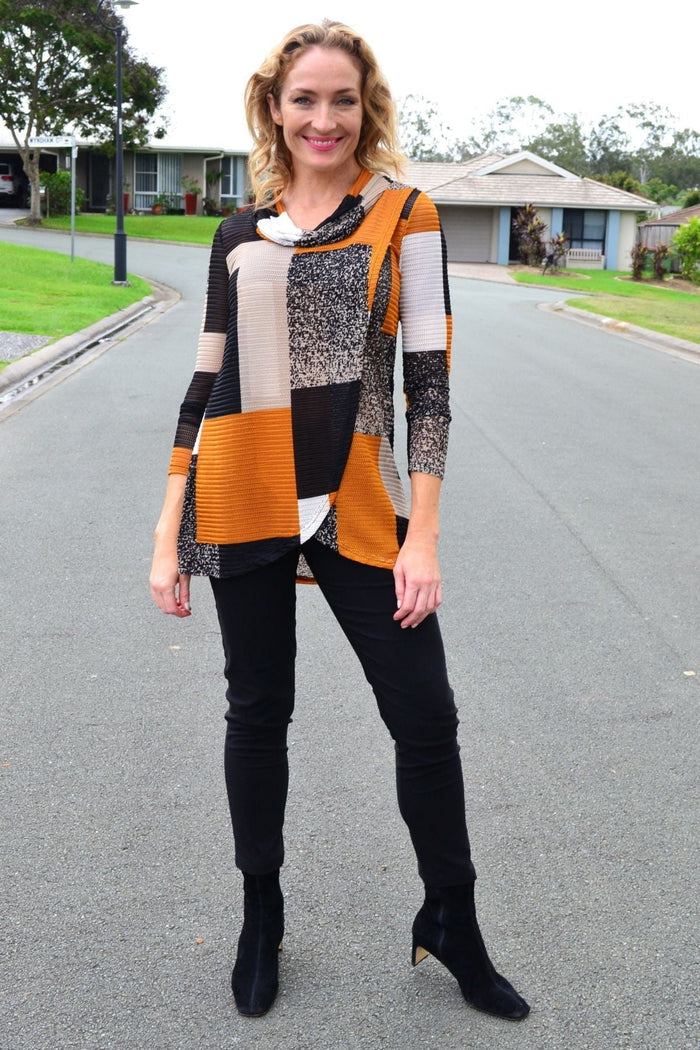 Caramel cowl neck tunic top by Caroline Morgan displayed on a hanger, showcasing its soft fabric and relaxed fit.