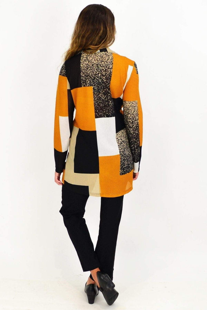 Caramel Caroline Morgan cowl neck tunic top displayed on a hanger, showcasing its soft fabric and relaxed fit.