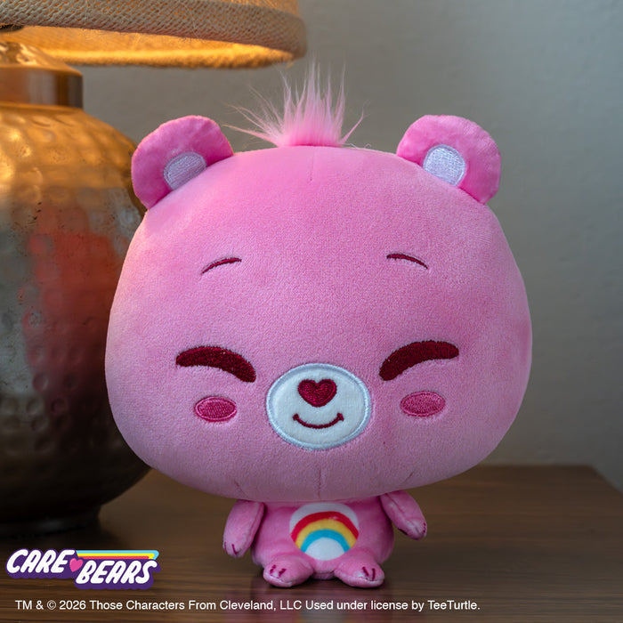 Cheer Bear Care Bears Cloudhead sitting on a wooden table next to a lamp