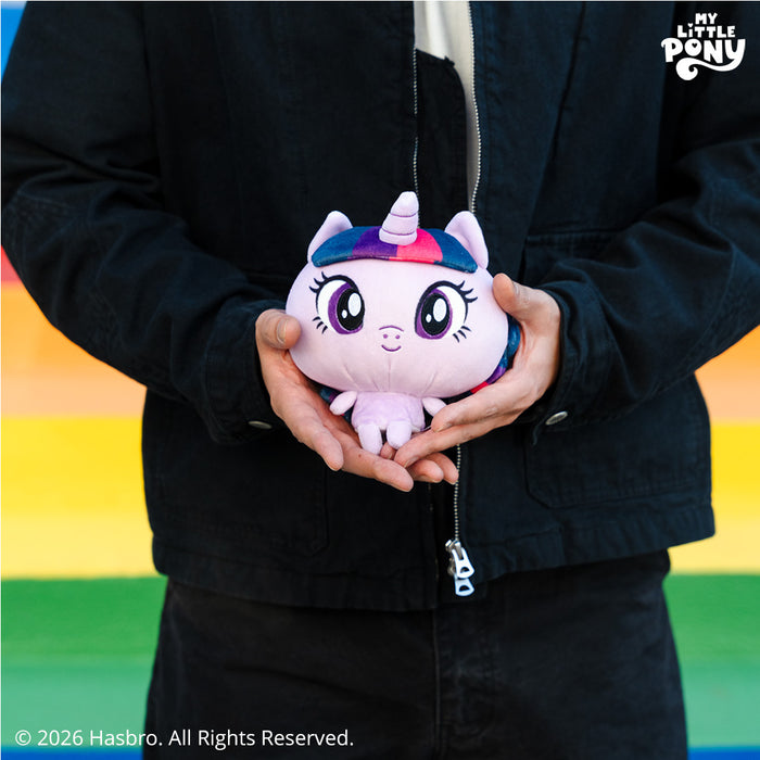 Cloudheads: 5" Twilight Sparkle held by a person in dark clothing against a rainbow stripe background