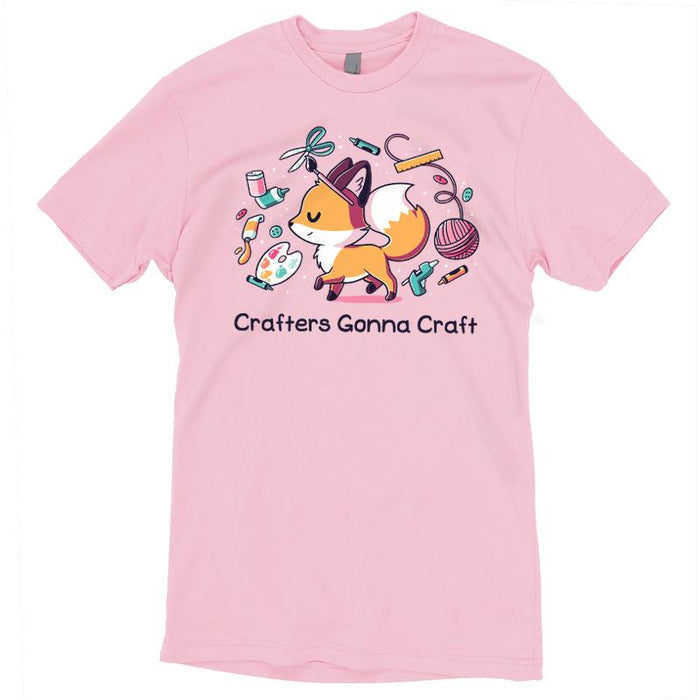 Premium Cotton T-shirt_TeeTurtle light pink Crafters Gonna Craft apparel featuring happy fox surrounded by crafting items such as paint, scissors, yarn, and glue. Caption below reads, "Crafters Gonna Craft".