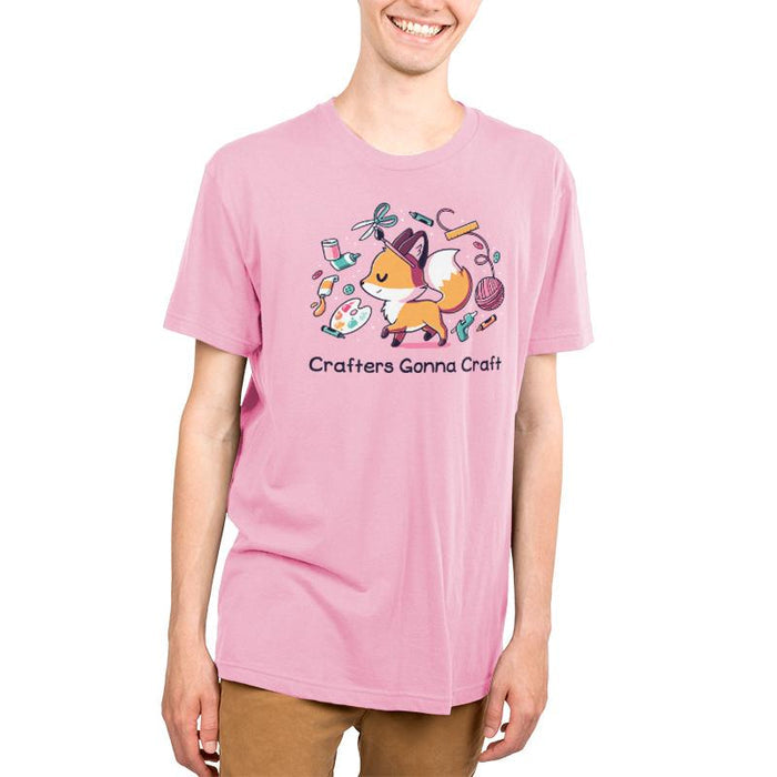 Premium Cotton T-shirt_TeeTurtle light pink Crafters Gonna Craft apparel featuring happy fox surrounded by crafting items such as paint, scissors, yarn, and glue. Caption below reads, "Crafters Gonna Craft".