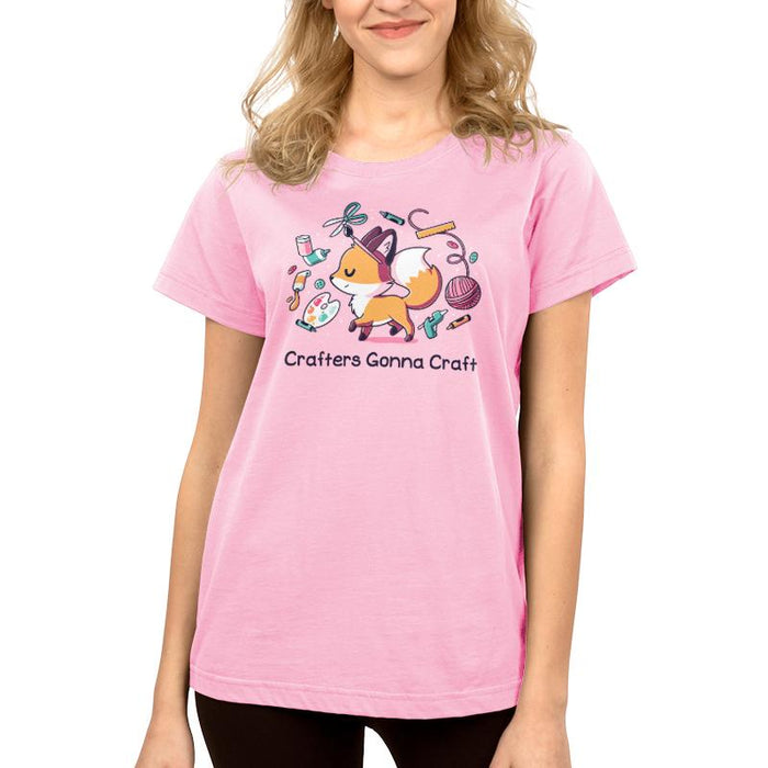 Premium Cotton T-shirt_TeeTurtle light pink Crafters Gonna Craft apparel featuring happy fox surrounded by crafting items such as paint, scissors, yarn, and glue. Caption below reads, "Crafters Gonna Craft".