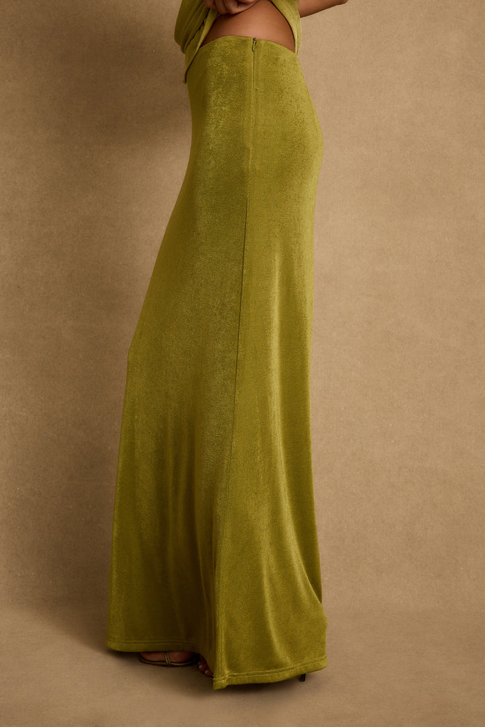 Side view of the chartreuse Eliana maxi skirt, floor-length with a soft velvety texture.