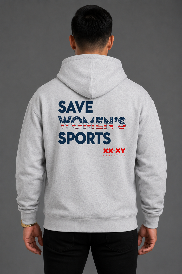 A man viewed from the back wearing a light gray hoodie with a large graphic on the back reading 'SAVE WOMEN'S SPORTS' in navy and red, plus 'XX-XY' branding, against a dark gray studio background. || Heather Gray