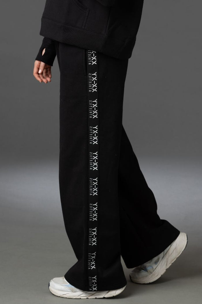 Black pants with white text design on a gray background || BLACK