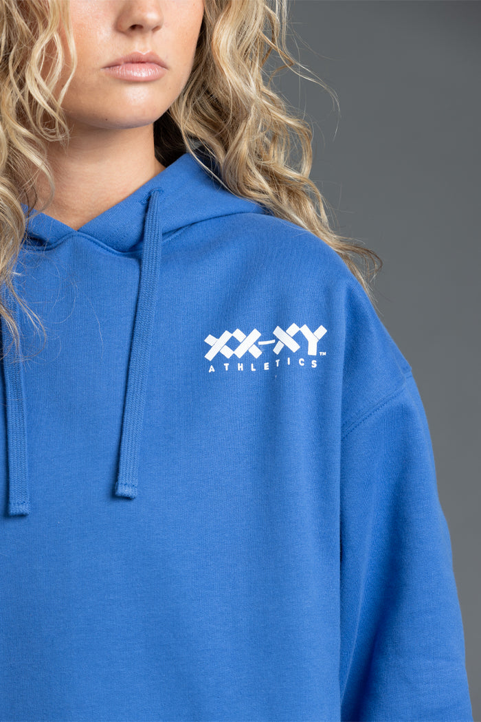 Person wearing a blue hoodie with 'XXXY Athletics' logo || Blue