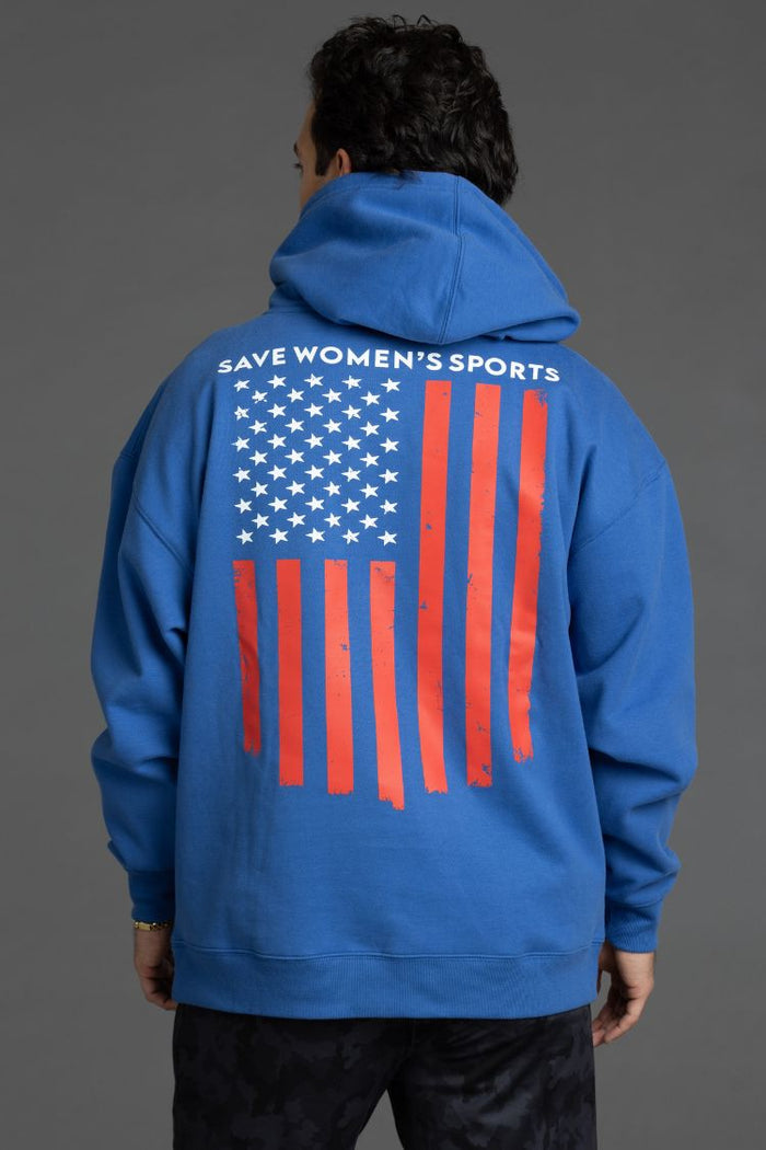 Person wearing a blue hoodie with an American flag and text on the back || Blue