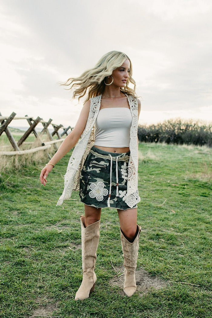 Camo western mini skirt styled for country concert outfits, edgy cowgirl fashion, western festival looks and boho country style from Sand + Charcoal Boutique