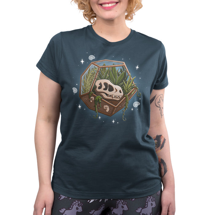 Premium Cotton T-shirt_TeeTurtle Flora Fossils denim blue t-shirt featuring an illustration of a skull in a hexagonal glass terrarium with various plants growing inside, surrounded by small stars and swirls.