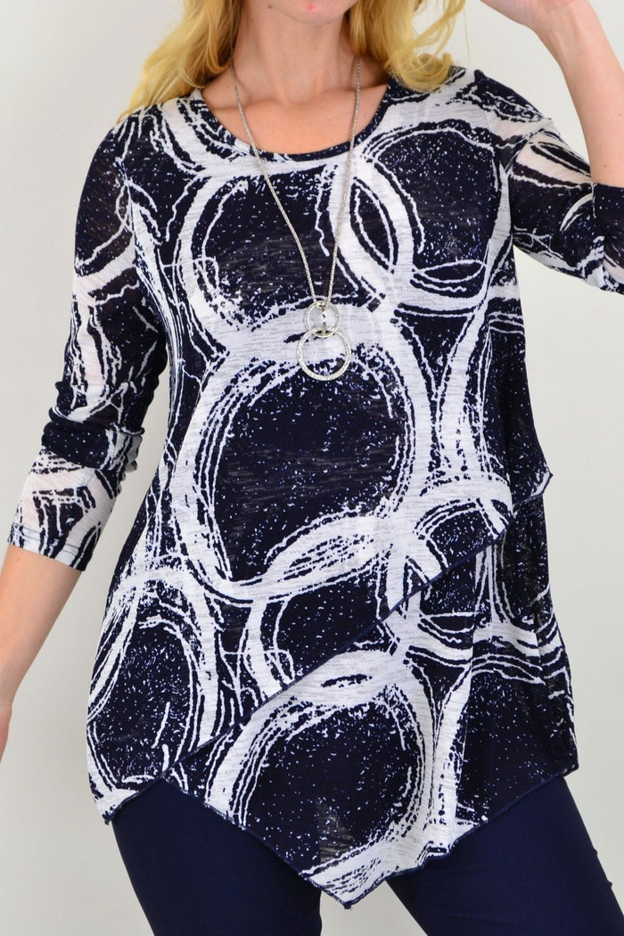 Caroline Morgan Galaxy Cross Over Swing Tunic Top displayed on a hanger, showcasing its flowing fabric and stylish design.