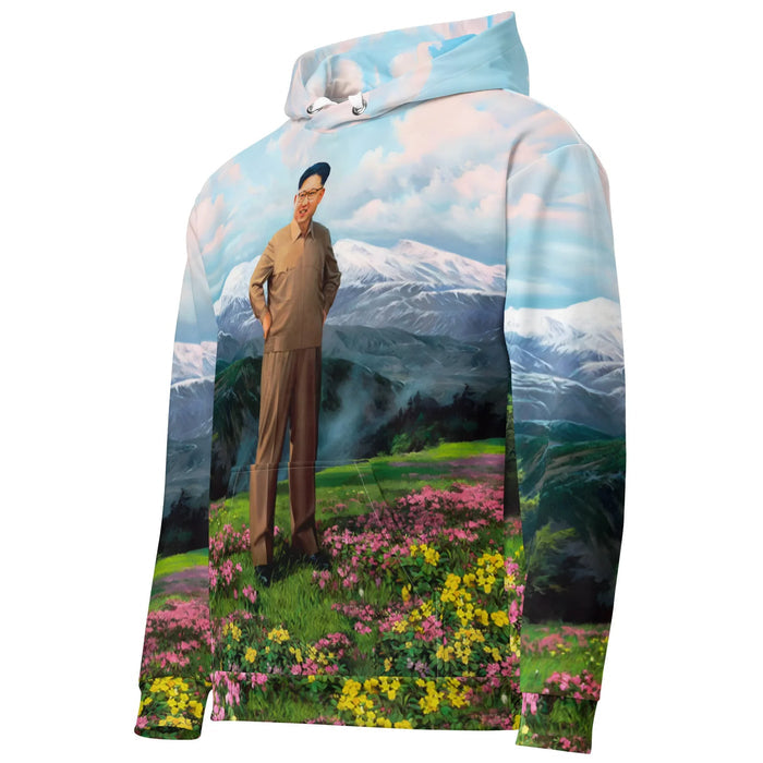 Glorious Dear Leader Hoodie - The beaming expression of the central figure in the monochromatic khaki suit (#9C8A74) set against the hyper-idealized utopian floral backdrop in azalea magenta (#CF6BA9) and stratosphere blue (#8ECBE8).