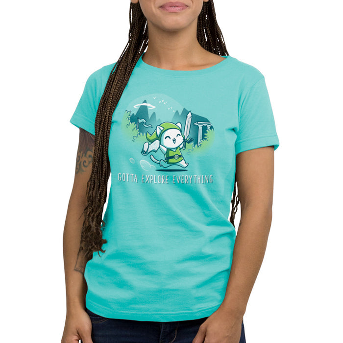Premium Cotton T-shirt_TeeTurtle Gotta Explore Everything Caribbean Blue apparel featuring an excited magical cat holding a map and sword running through the mountains.