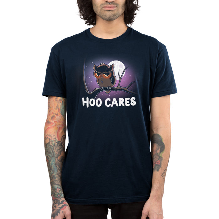 Premium Cotton T-shirt_TeeTurtle navy blue Hoo Cares apparel featuring an owl with a deadpan expression perched on a branch with a moonlit sky in the background with the caption, “Hoo Cares“.