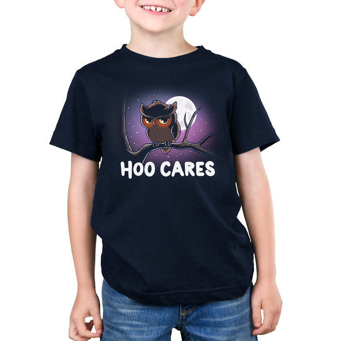 Premium Cotton T-shirt_TeeTurtle navy blue Hoo Cares apparel featuring an owl with a deadpan expression perched on a branch with a moonlit sky in the background with the caption, “Hoo Cares“.
