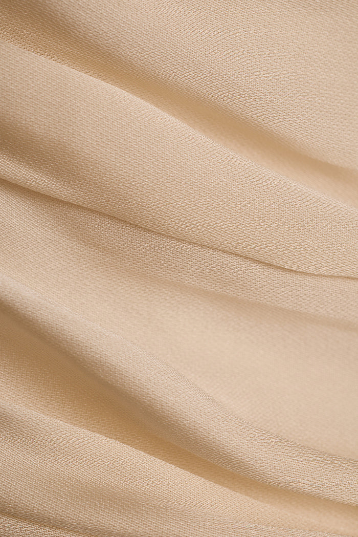 Close-up of cream satin fabric on the Inez maxi dress, showing soft draped folds.