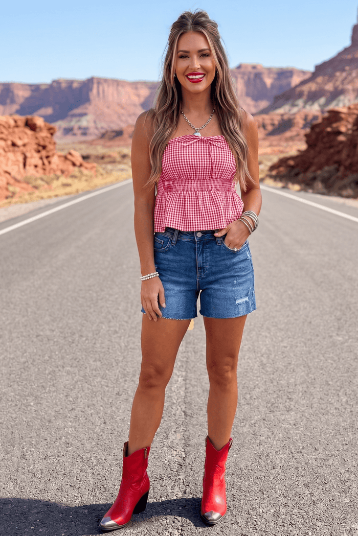 Classic high rise denim shorts with a flattering fit and raw hem detail, styled for Americana outfits, summer BBQs, Fourth of July celebrations, country concerts, and rodeo-ready fashion.