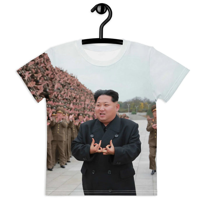 A recognizable East Asian political leader in a dark obsidian peacoat throws satirical street hand gestures while standing before a massive, applauding military crowd. Contact us with accessibility feedback, we'd love to help!