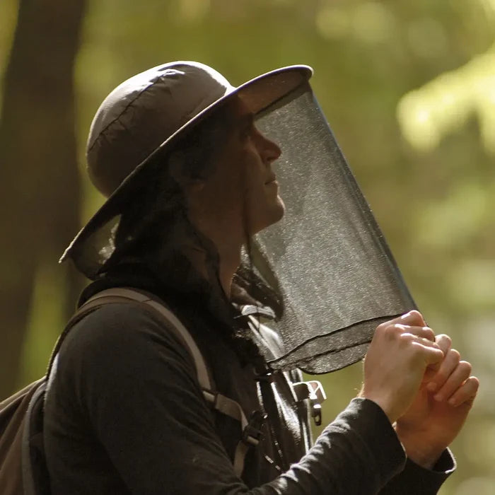 Person wearing a Lifesystems Pop-Up Midge and Mosquito Head Net Hat in a tropical setting