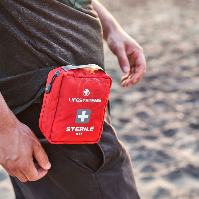 Lifestyle image of a man wearing a Lifesystems sterile first aid kit case on their belt