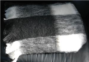 Folded Alpaca fleece throw in Friesian colour.