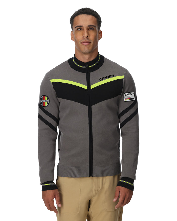 Man wearing a gray jacket with black and yellow accents on a white background