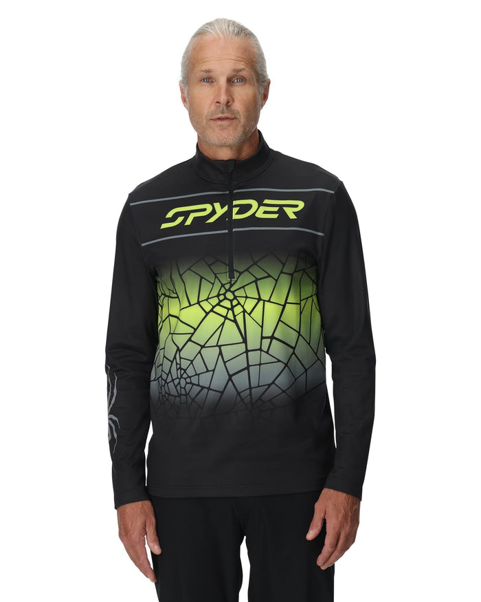Person wearing a black and green Spyder jacket on a white background