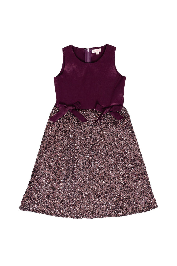 The Mini Alexis Dress in Wine by Ivy City Co is a sleeveless girls’ festive dress with a solid wine-colored top, two side bows at the waist, and a matching sparkling sequin skirt, beautifully displayed flat on a white background.