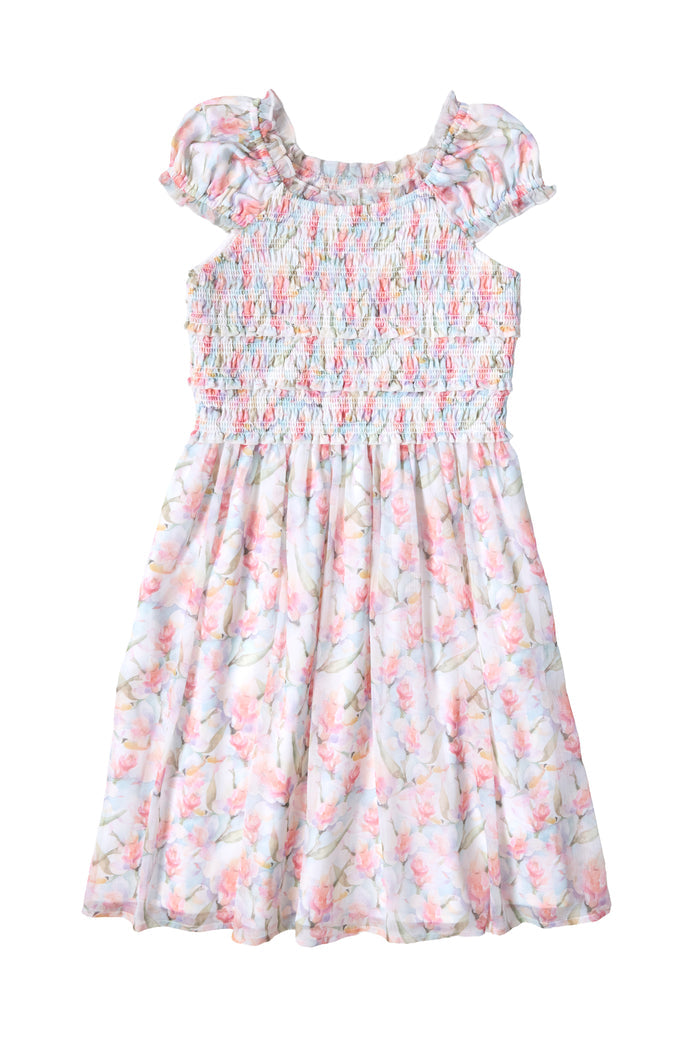 Ivy City Co’s Mini Kyla Dress in Watercolor Orchids features a smocked bodice, ruffled neckline, puff sleeves, and a flowy A-line skirt with pastel orchid prints—perfect for any special occasion.