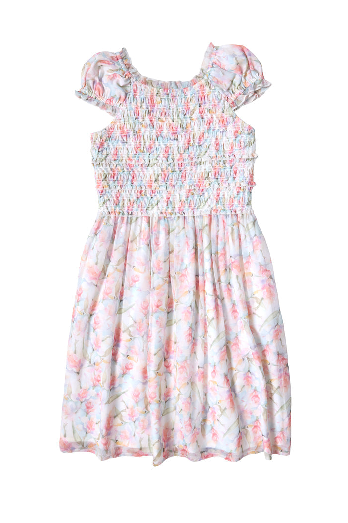 The Ivy City Co Mini Kyla Dress in Watercolor Orchids features a light chiffon design with short puff sleeves, a smocked bodice, and a flared skirt. Soft pastel florals bloom on white for a sweet look.