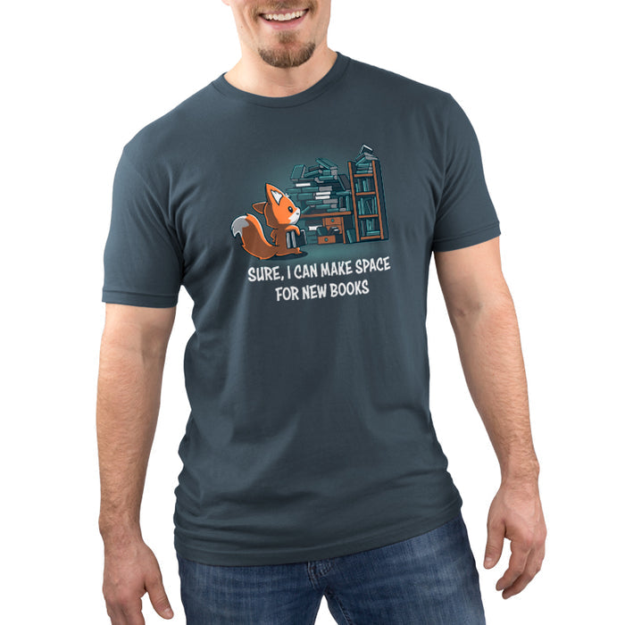 Premium Cotton T-shirt_TeeTurtle denim blue Never-Ending Bookshelf apparel featuring a fox holding a book standing in front of an overflowing book and desk with the caption, “Sure, I can Make Space for New Books“.