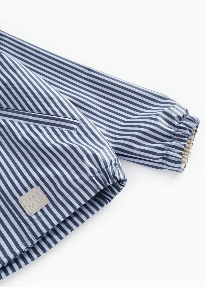 Blue stripe rain jacket with hood, zipper, and elastic at the sleeve edge.