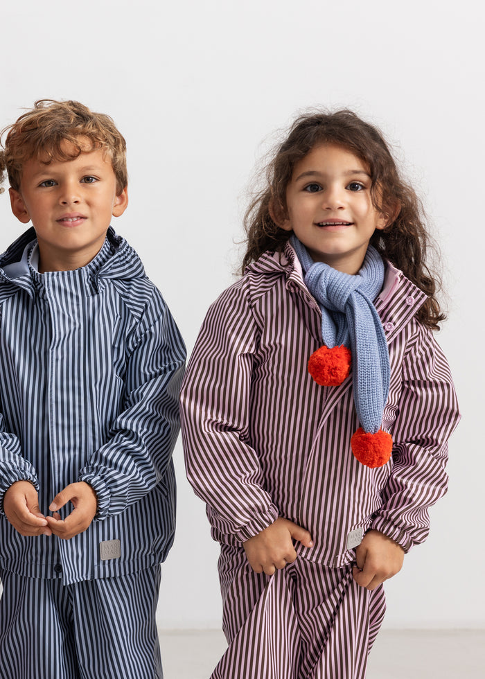 Children's raincoat in pink and brown stripes with hood and red drizzle.